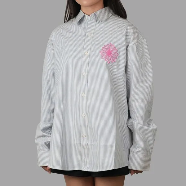 Mardi Mercredi Flowermardi Oxford Shirt Sky Pink dengan bordir bunga Mardi Mercredi di dada, berbahan cotton berstruktur, berpotongan relaxed fit dan cocok untuk gaya kasual formal