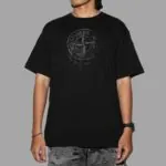 Kaos Stone Island warna hitam dengan print "Stamp One" khas di bagian dada, desain minimalis dan bold untuk gaya streetwear premium